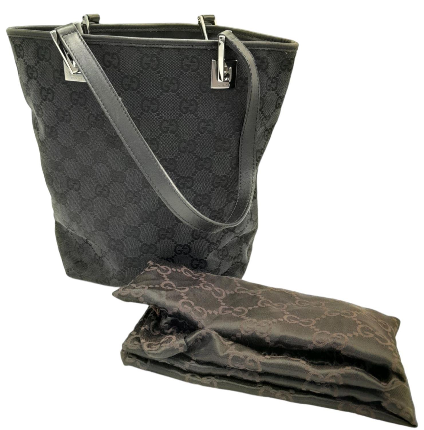 A Gucci Black Monogram Tote Bag. Canvas exterior with leather trim, two leather straps and silver- - Image 3 of 8