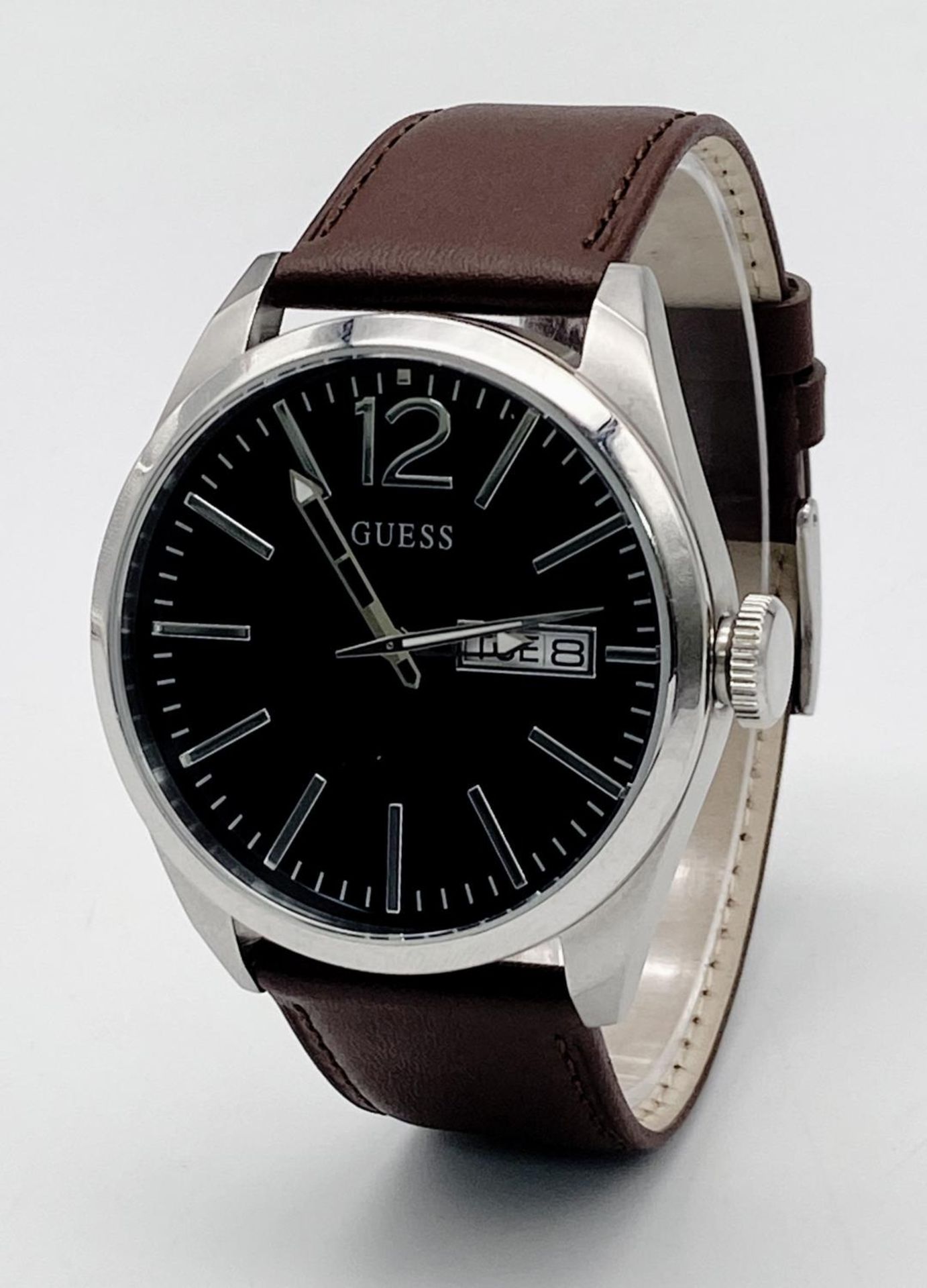 A Large Cased Guess Designer Watch. Brown leather strap. Stainless steel case - 46mm. Black dial