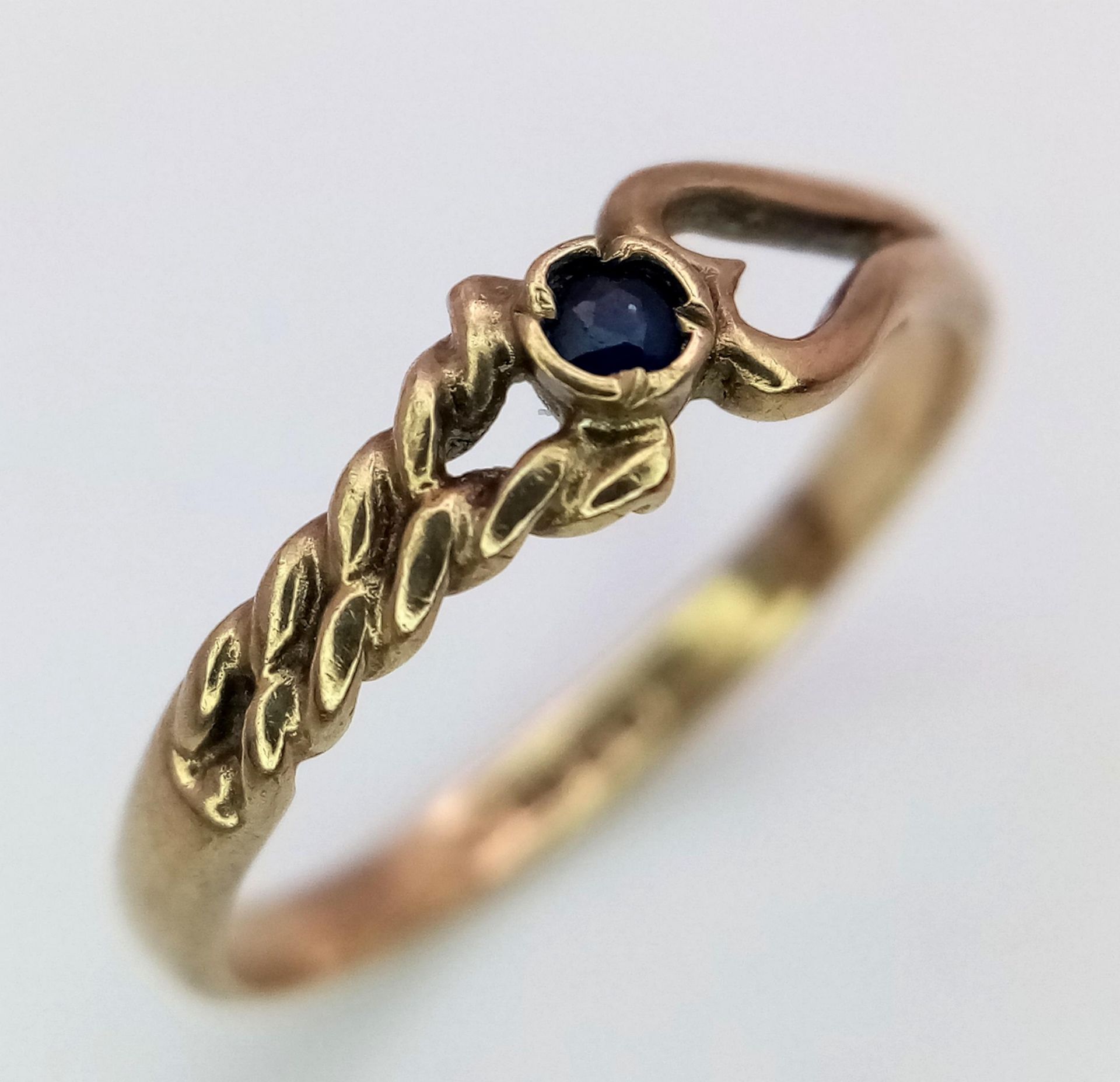 A 9K Yellow Gold and Sapphire Love Ring. Size J. 1.1g weight.