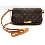 A Louis Vuitton Favourite PM Bag. Monogramed canvas exterior with gold-toned hardware, thin