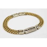 An 18K Yellow and White gold Diamond Bracelet. A double row of flat yellow gold curb links connect