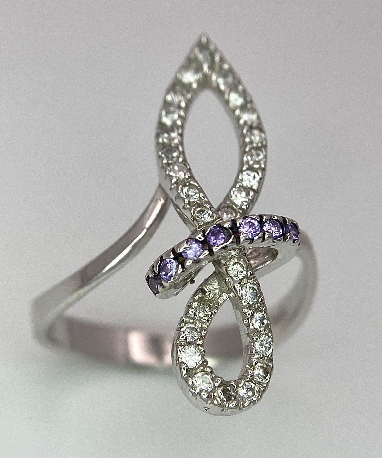 An 18K White Gold CZ Fancy Knot Ring. Size O. 3.9g weight.