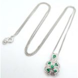 A 9K White Gold Emerald Clover Pendant on Necklace. Comes with presentation case. 1.4cm pendant,