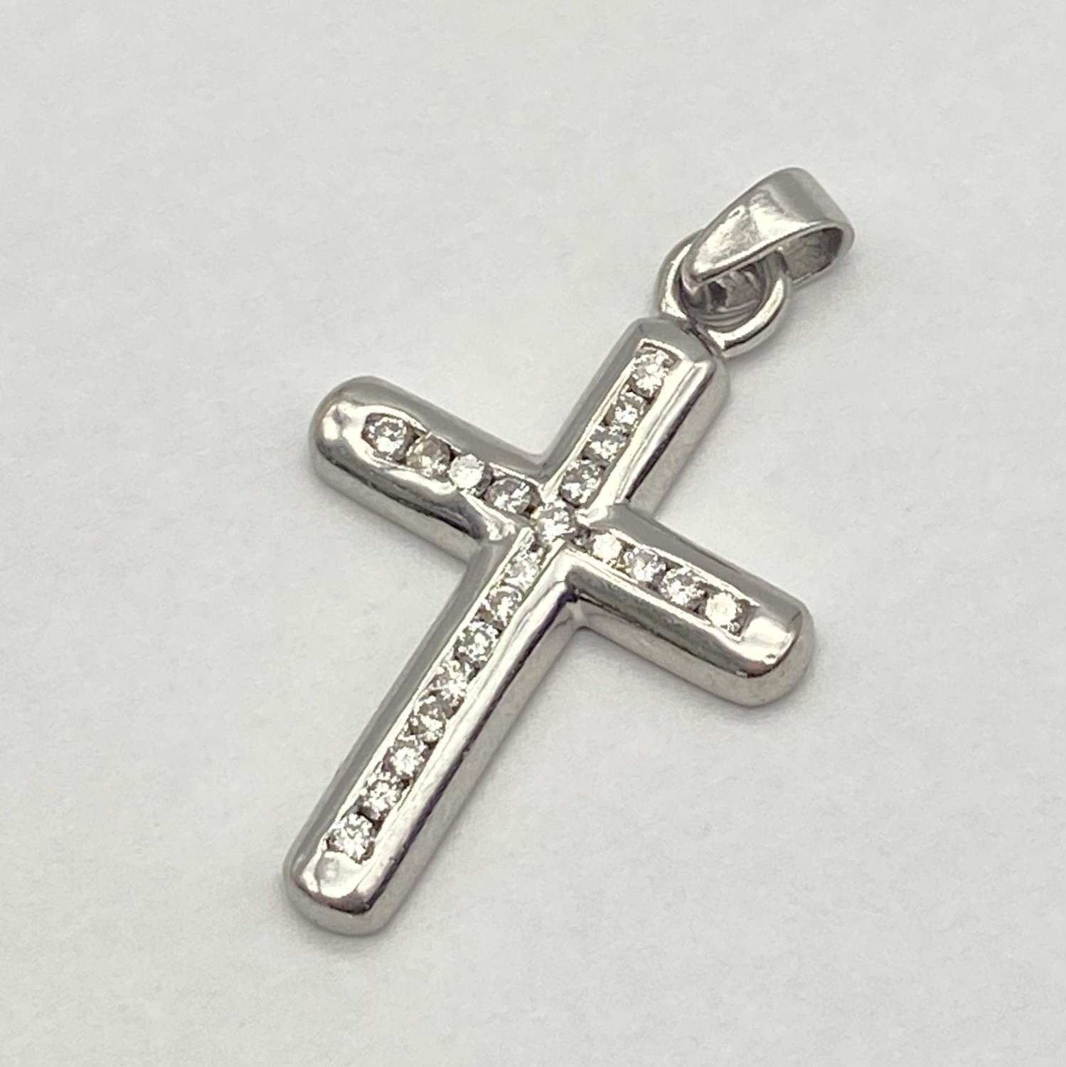 A 9K White Gold Diamond Cross Pendant. 4cm x 2cm. 4.5g total weight.