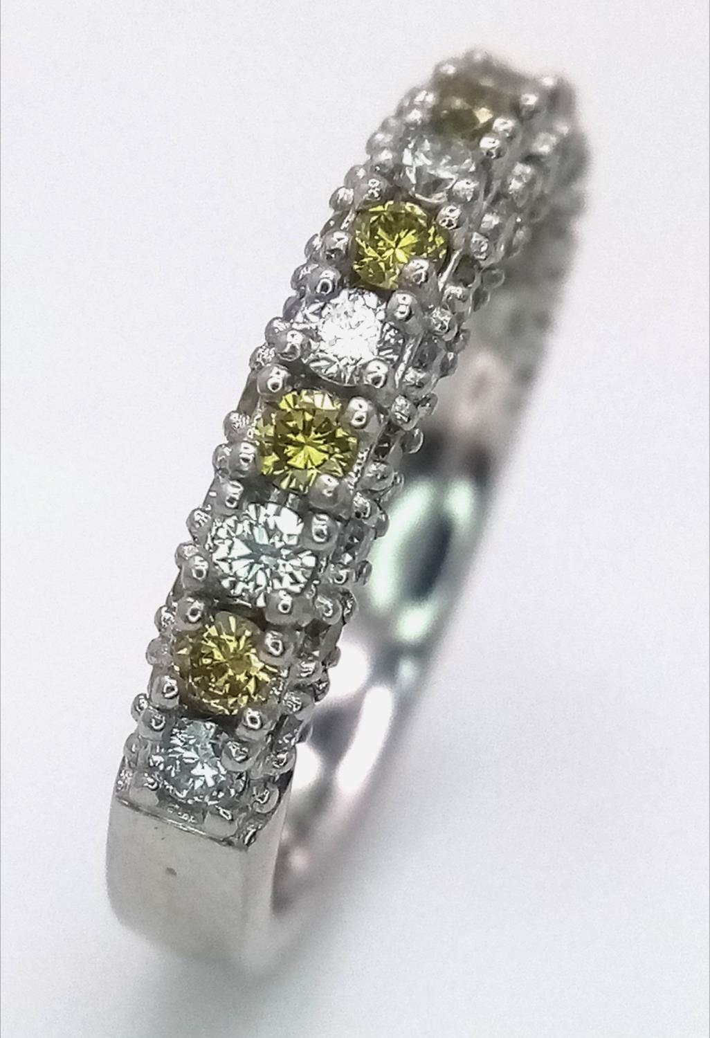 A Platinum White and Yellow Diamond Three-Sided Half Eternity Ring. Size L. 6.3g total weight. - Image 7 of 9
