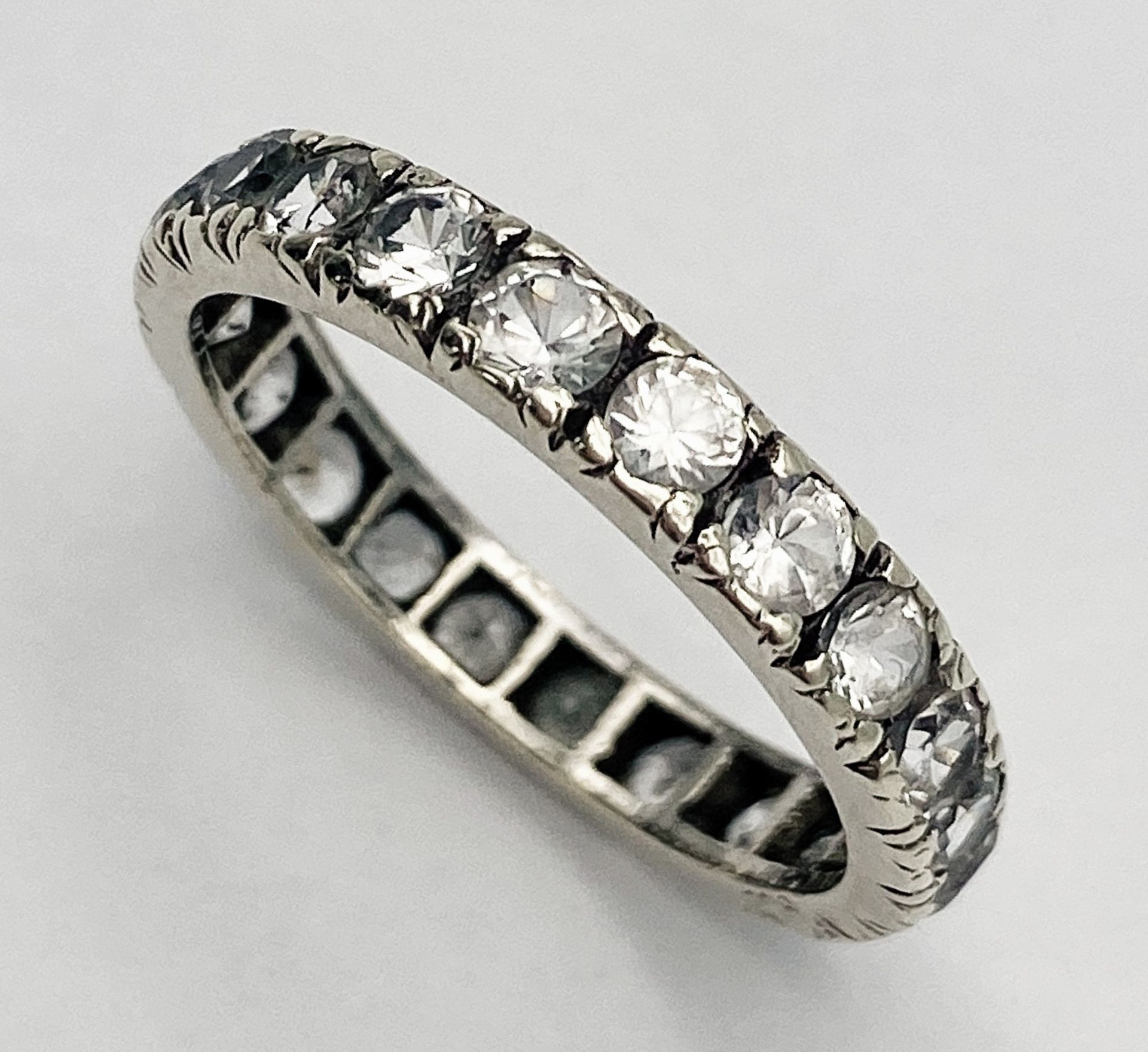 A VINTAGE 9K WHITE GOLD (TESTED) WHITE STONE FULL ETERNITY RING. 2.5G. SIZE 0. - Image 3 of 6
