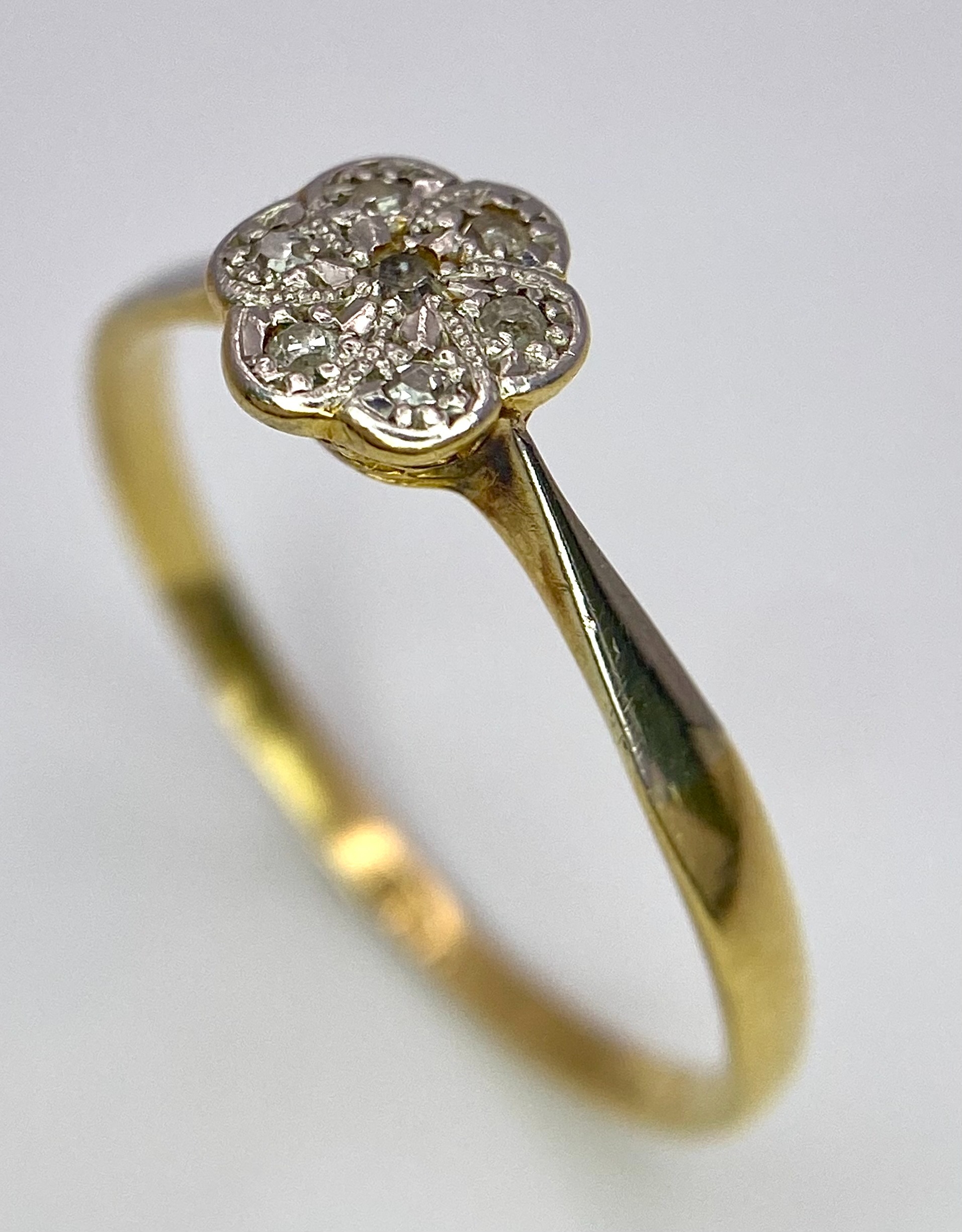 An 18K Yellow Gold, Platinum Diamond Ring. Size Q. Seven old cut diamonds in a decorative floral - Image 3 of 6