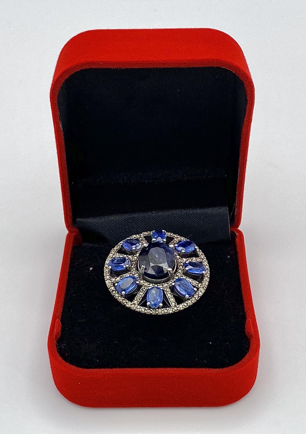A 10ct Topaz Ring with 6.15ctw of Kyanite surround and 0.50ctw of Diamond Accents. Set in 925 - Image 6 of 6
