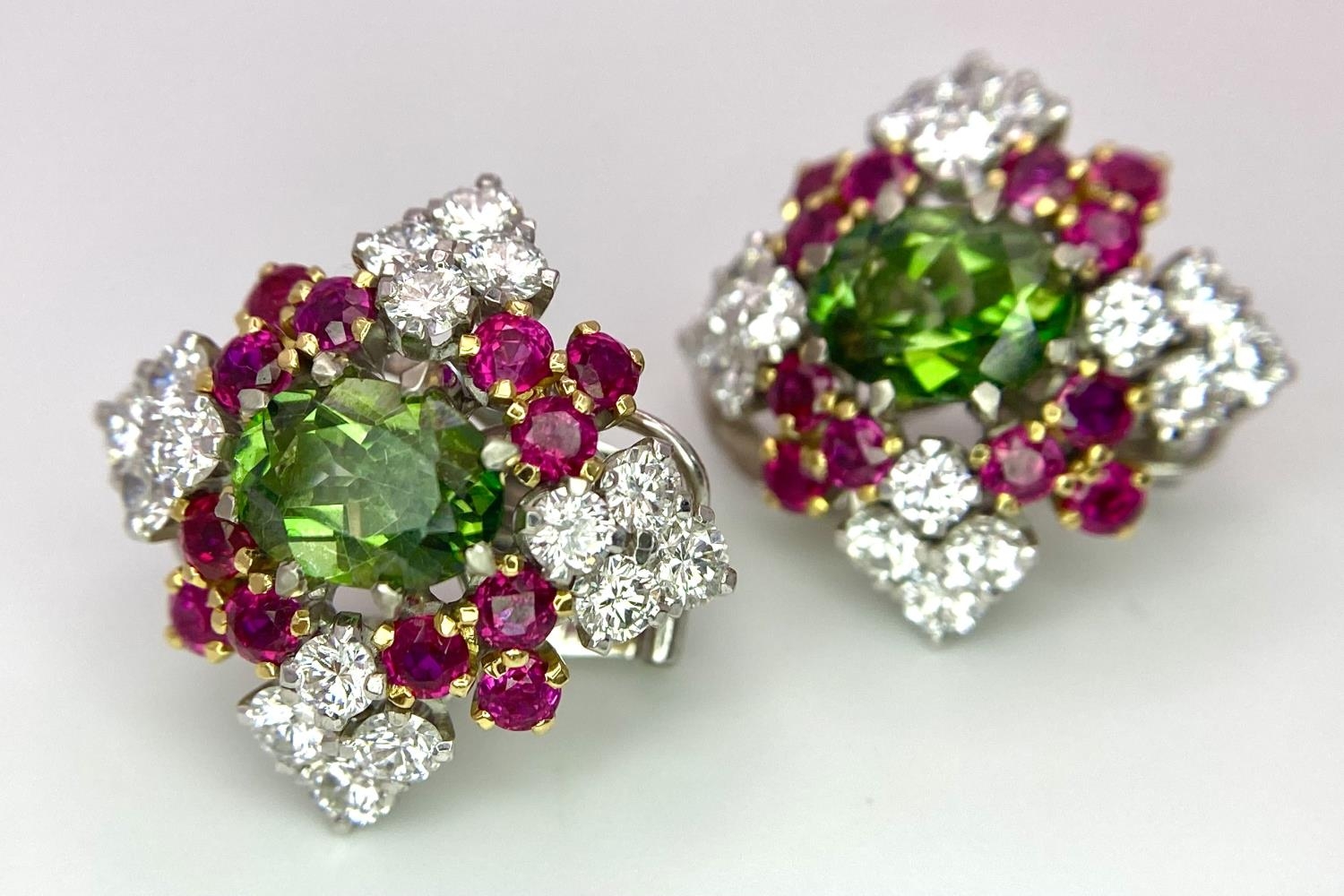 A Pair of Platinum, Emerald, Ruby and Diamond Earrings. Each earring containing a 1.5ct oval cut - Image 3 of 5