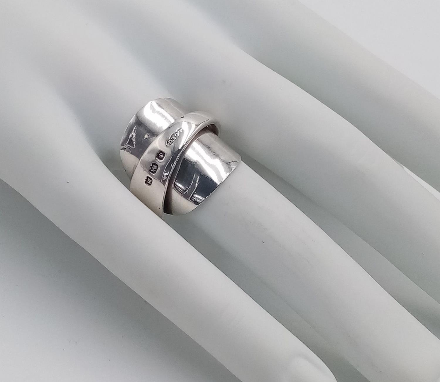 A STERLING SILVER FANCY RING HALLMARKED ON TOP BY J G LTD 6.8G SIZE K A/F. SC 9088