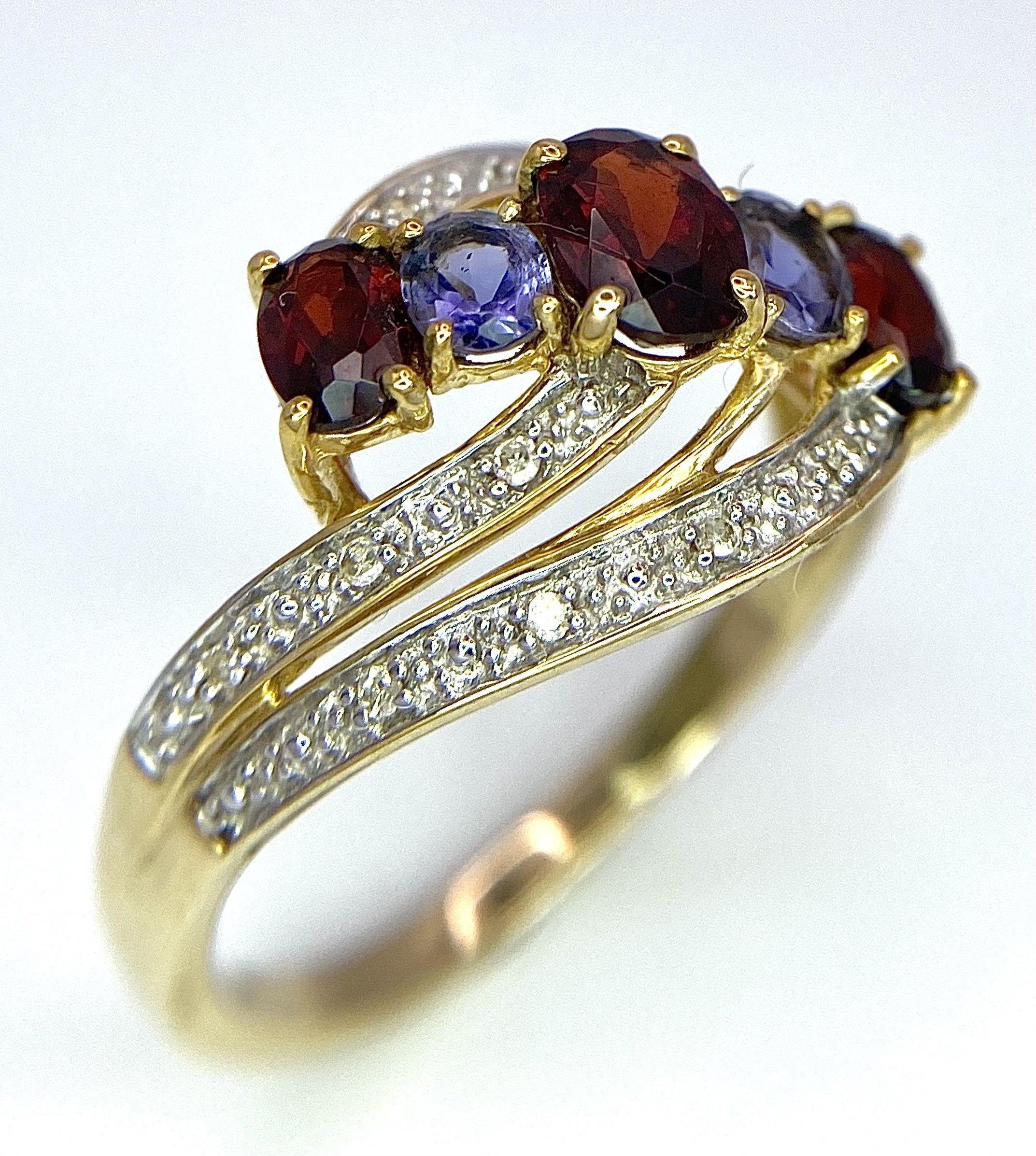 A 9 Carat Yellow Gold Garnet, Tanzanite and Diamond Set Crossover Ring Size P. Crown Measures 1. - Bild 2 aus 7