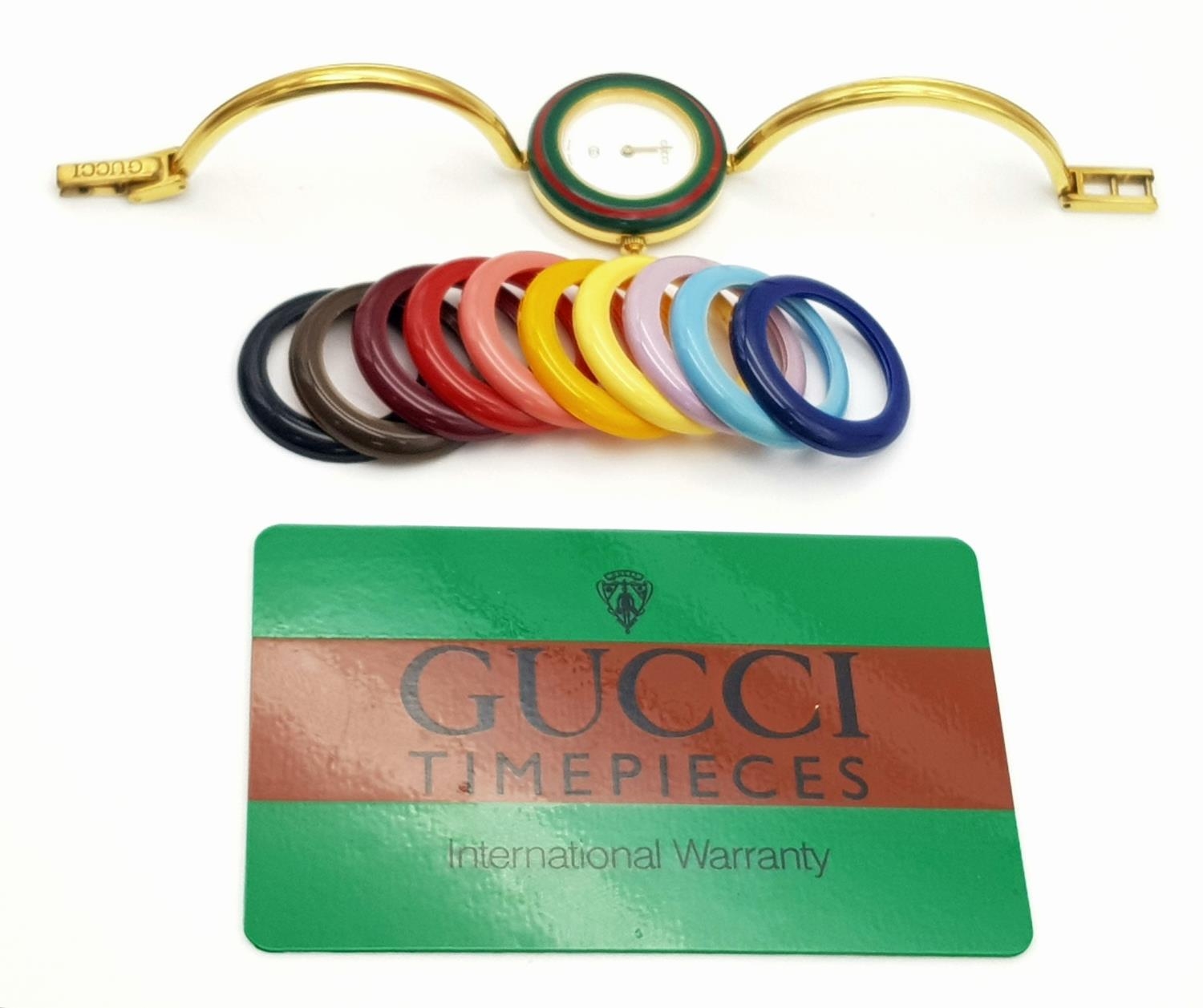 A Gucci Rainbow Bezel Multi-Change Quartz Ladies Watch. Comes with original warranty. Needs a