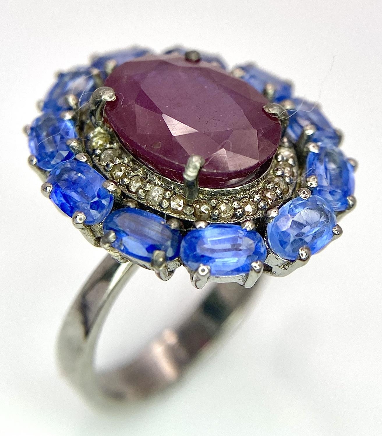 A 5.65ct Ruby Dress Ring with Halo of 0.40ctw of Diamonds and 3.70ct of Kyanite Stones. Set in 925 - Image 2 of 7