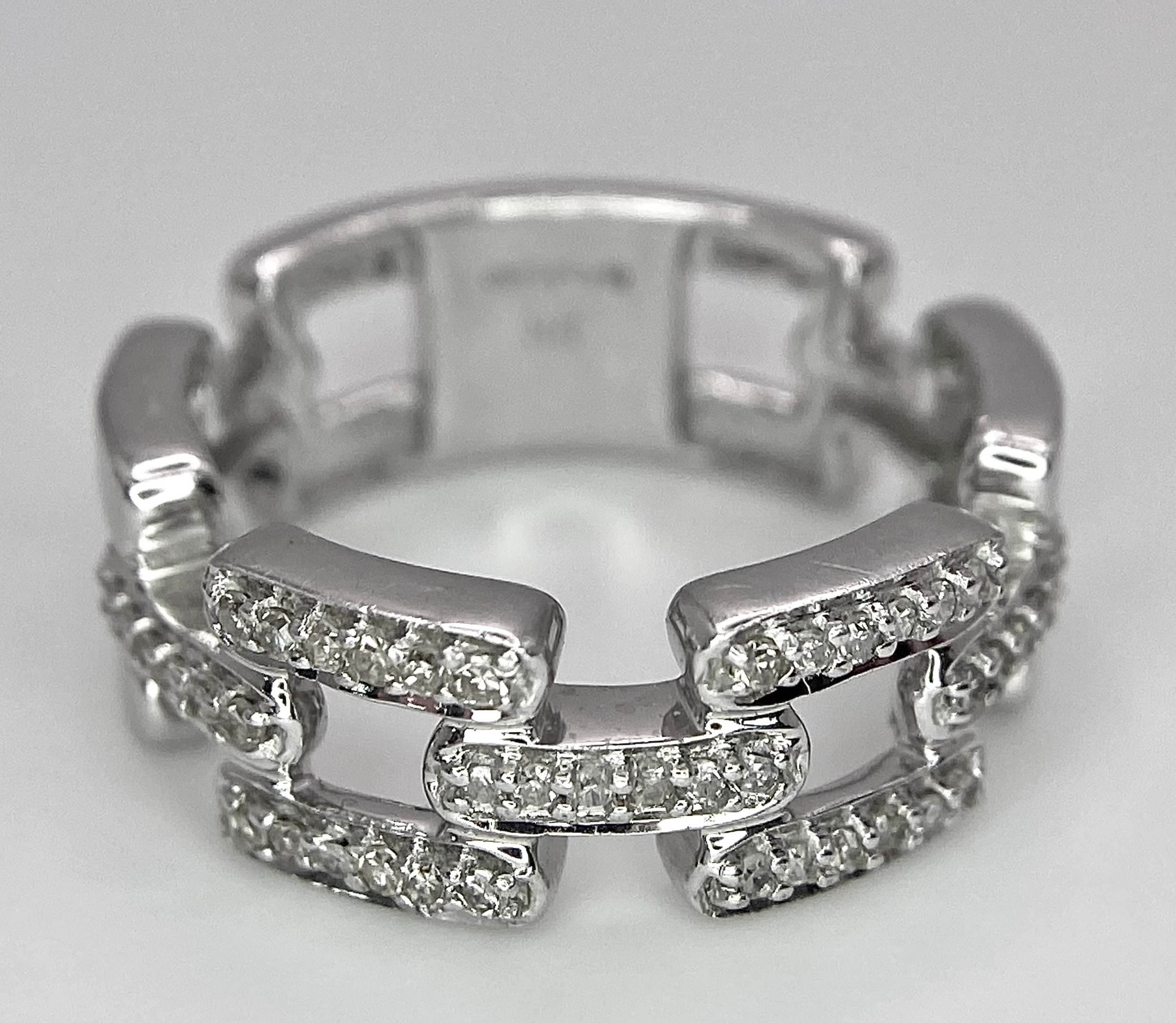 A 9K WHITE GOLD DIAMOND SET LINK RING. 0.25ctw, Size N, 4.7g total weight. Ref: SC 8003 - Image 2 of 6