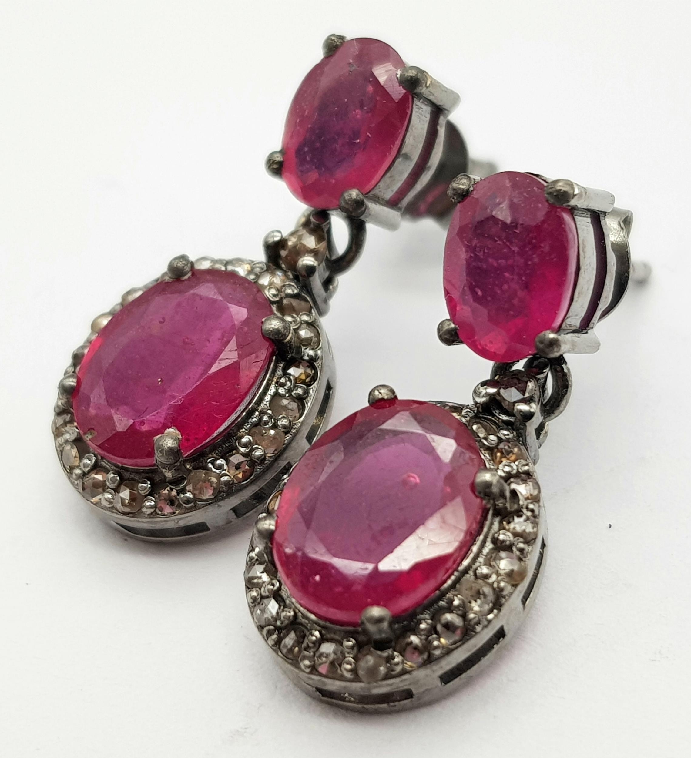 A Pair of Oval Cut Ruby and Rose cut Diamond Drop Earrings. Set in 925 Sterling silver. Ruby -5.