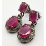 A Pair of Oval Cut Ruby and Rose cut Diamond Drop Earrings. Set in 925 Sterling silver. Ruby -5.
