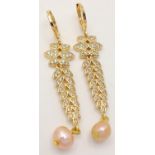 A fabulous gold-plated pair of earrings with cubic zirconia and pink cultured pearls, presented in a