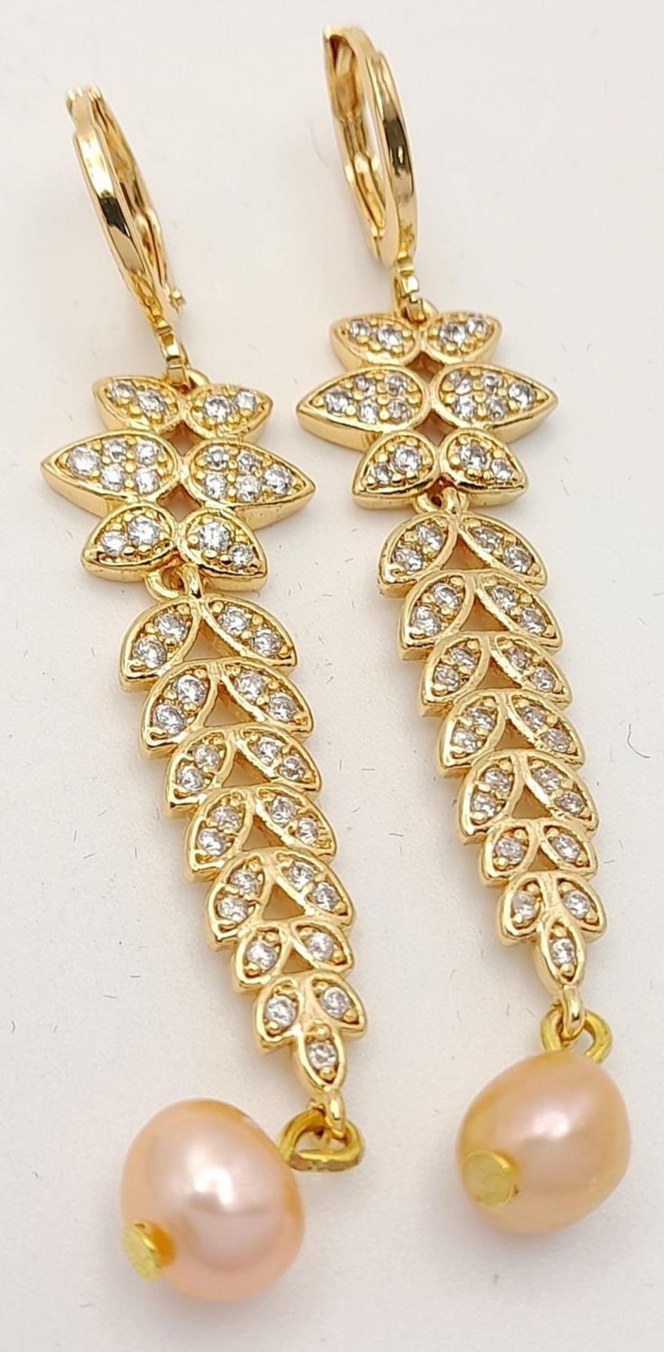 A fabulous gold-plated pair of earrings with cubic zirconia and pink cultured pearls, presented in a