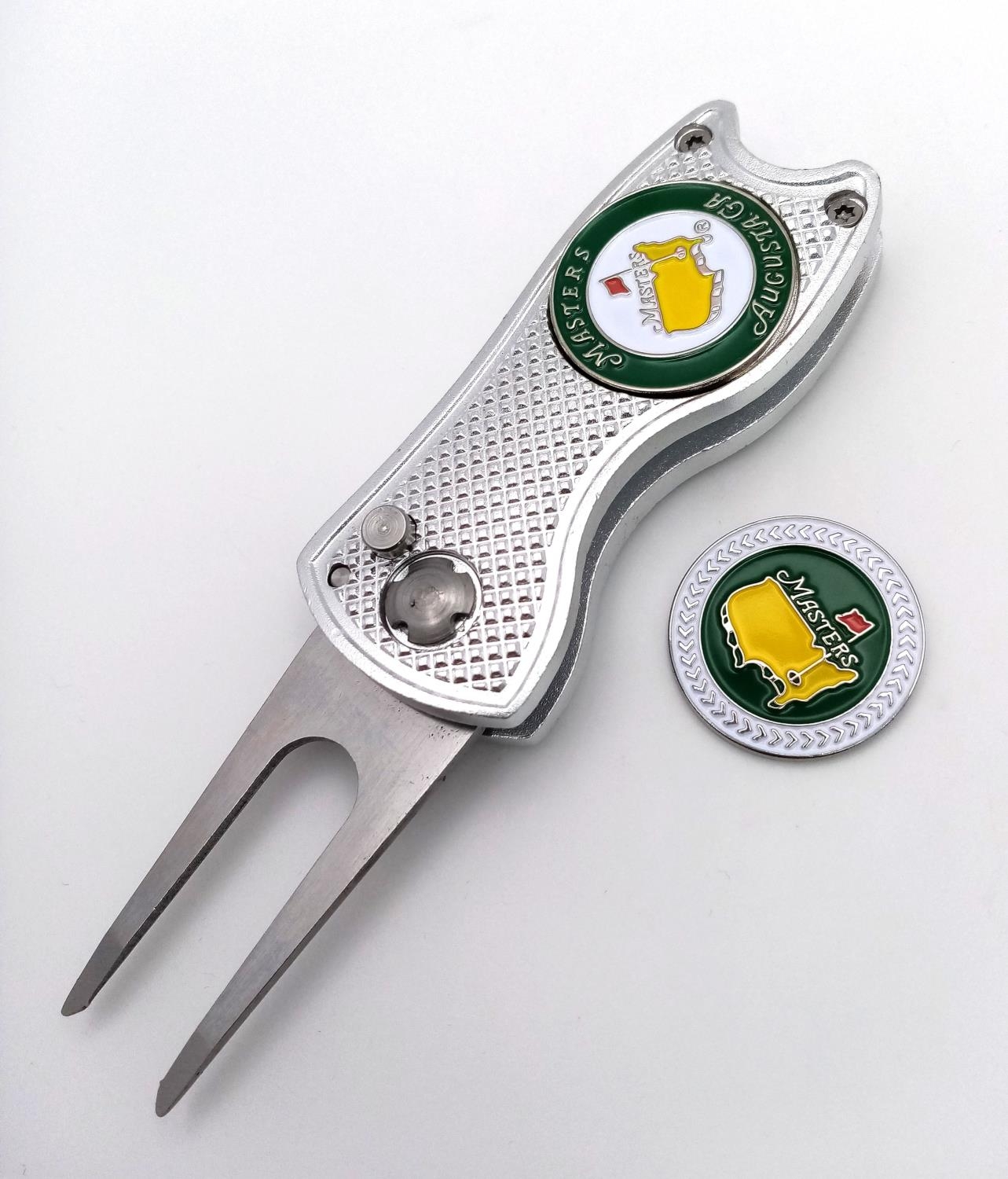 A 'Flick' Tool Golf Putting Green Divot Repairer with two Commemorative 'Masters' Ball Markers. As