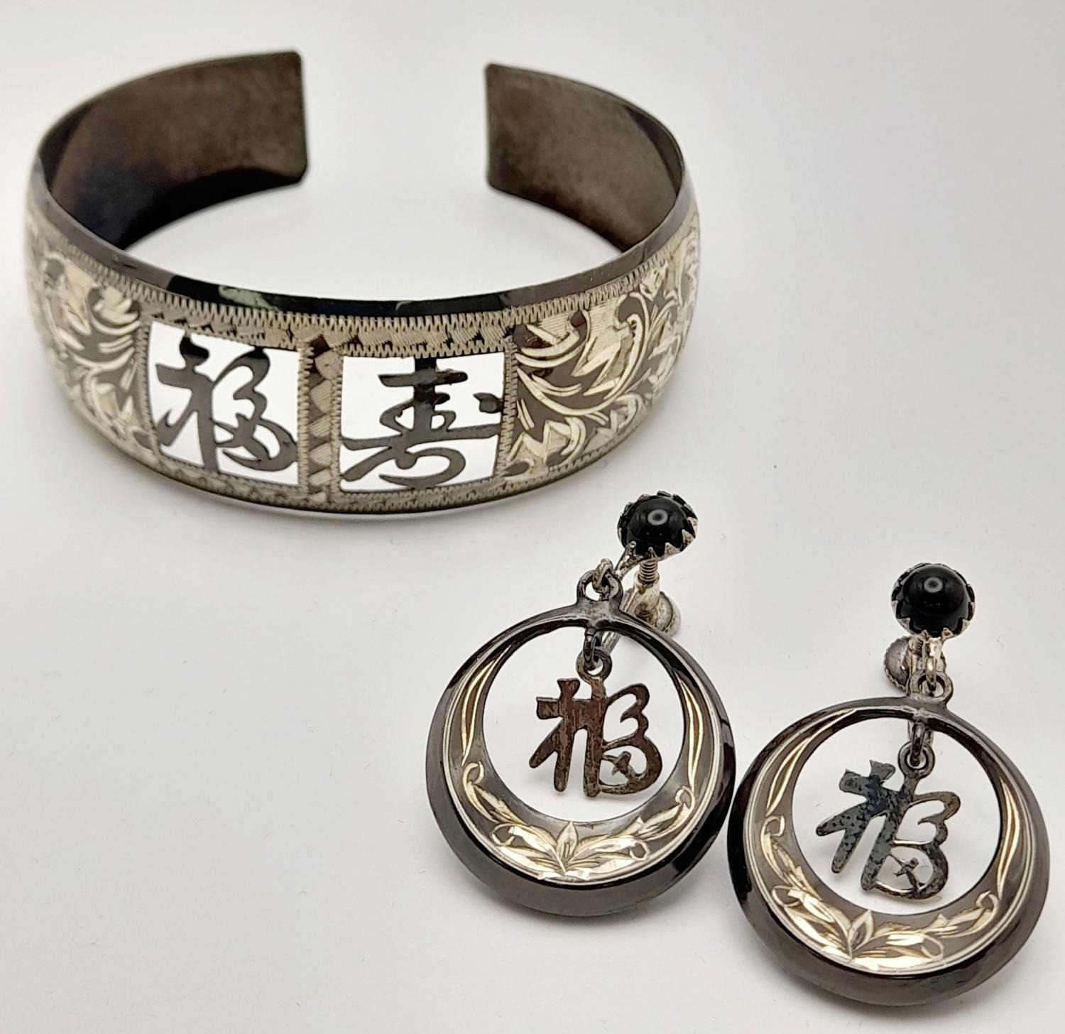 A vintage, Chinese, export quality, expertly hand carved, sterling silver bracelet and earrings