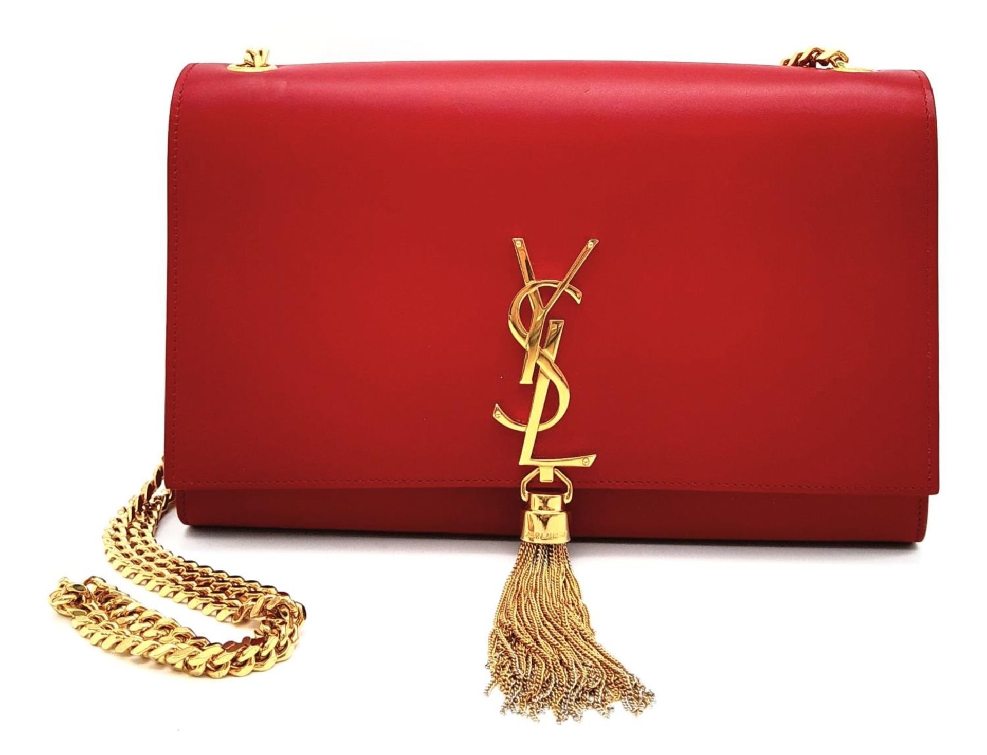 A YSL Red Kate Tassel Crossbody Bag. Leather exterior with gold-toned hardware, the iconic YSL logo,