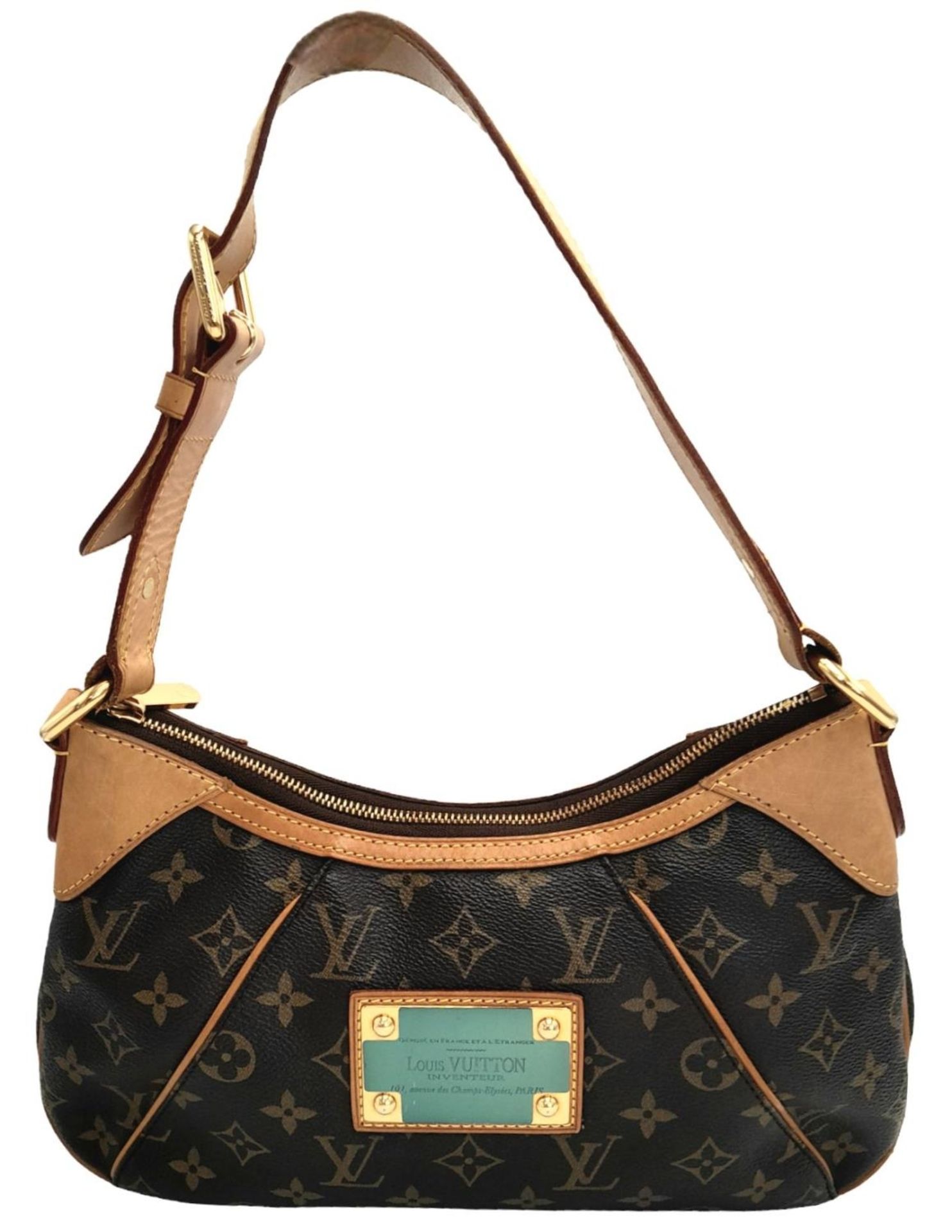 A Louis Vuitton Thames Shoulder Bag. Monogramed canvas exterior with gold-toned hardware, adjustable