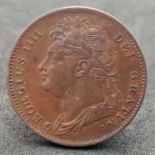 An 1822 George III Farthing.