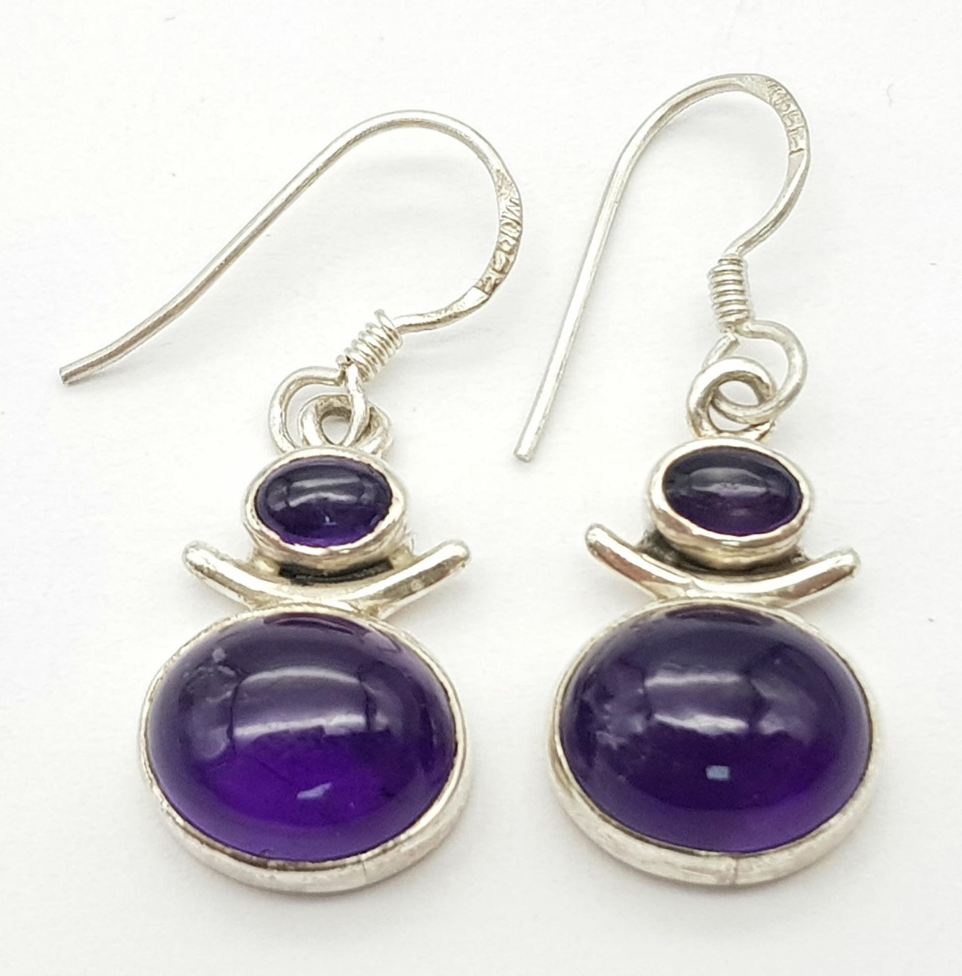 A Pair of Sterling Silver Oval Cut Amethyst Earrings. 3cm Drop. Set with a 1.2cm & 6mm Amethyst