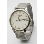 A Large Tissot Quartz Gents Watch. Stainless steel bracelet and case - 42mm. White dial with date