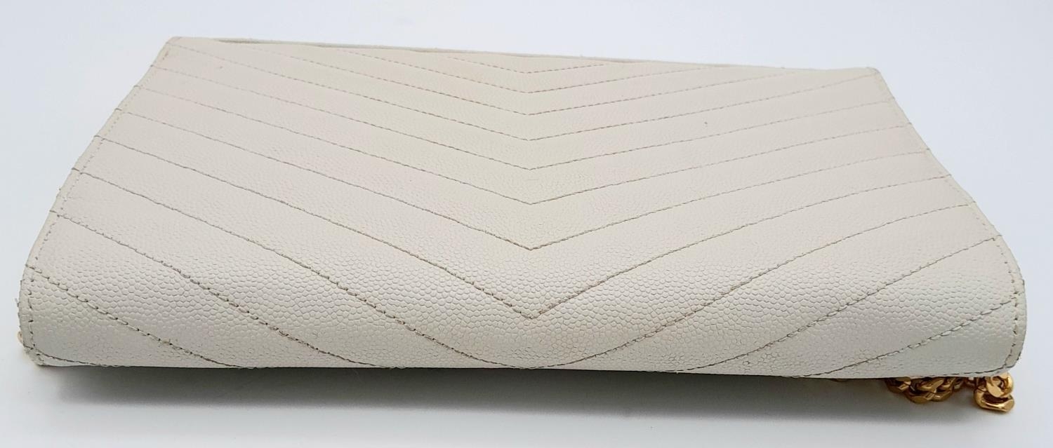 A YSL Ivory Cassandre Wallet Bag. Leather exterior with gold-toned hardware, the iconic YSL logo, - Image 4 of 13