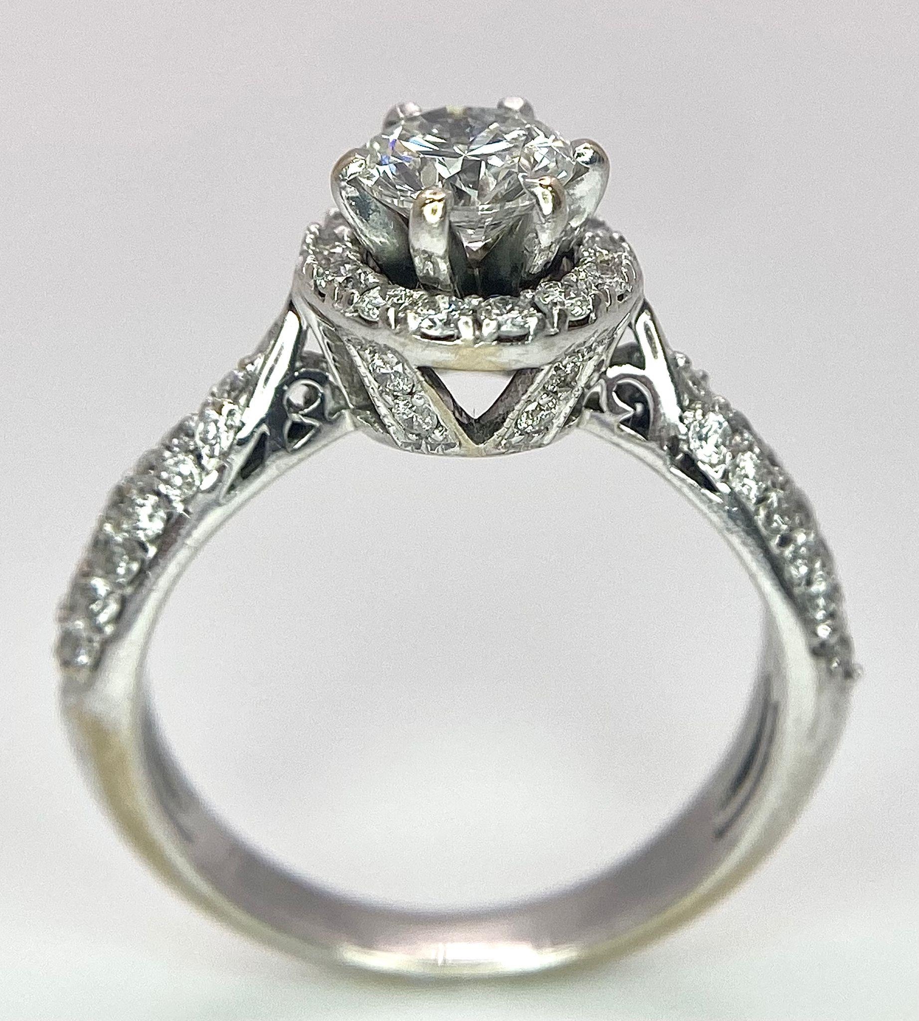 An 18K White Gold Diamond Ring. Central 0.75ct brilliant round cut diamond with a diamond halo and - Image 5 of 10