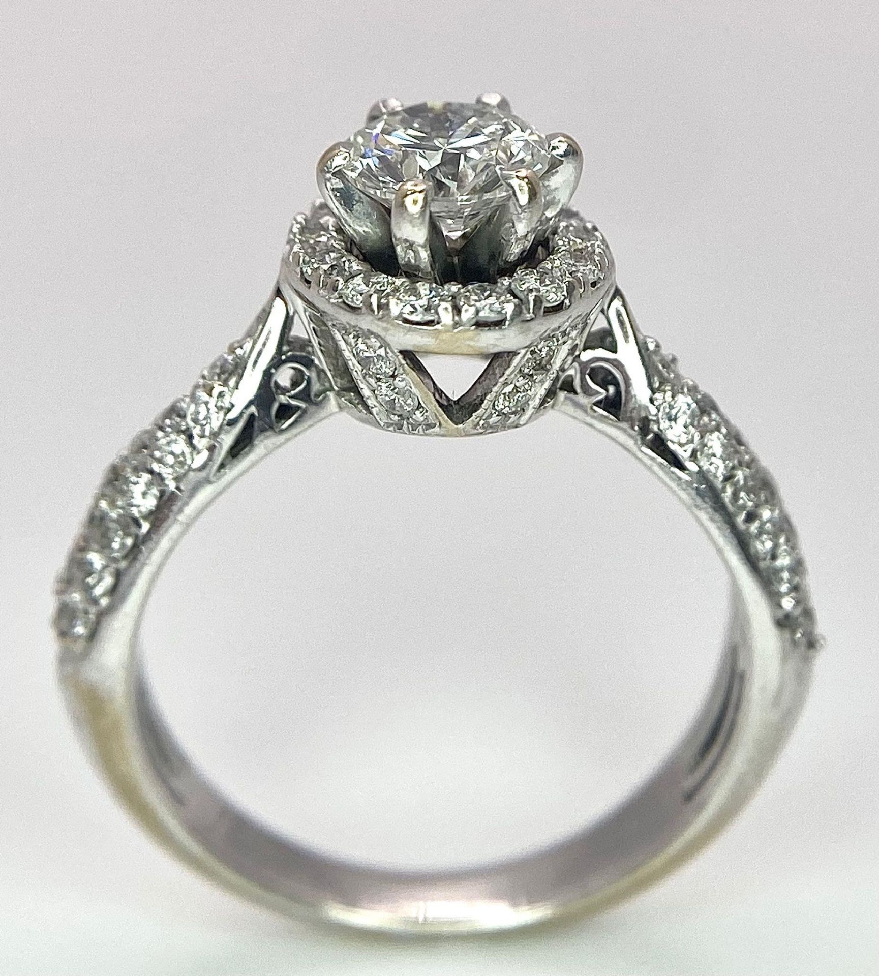 An 18K White Gold Diamond Ring. Central 0.75ct brilliant round cut diamond with a diamond halo and - Image 5 of 10