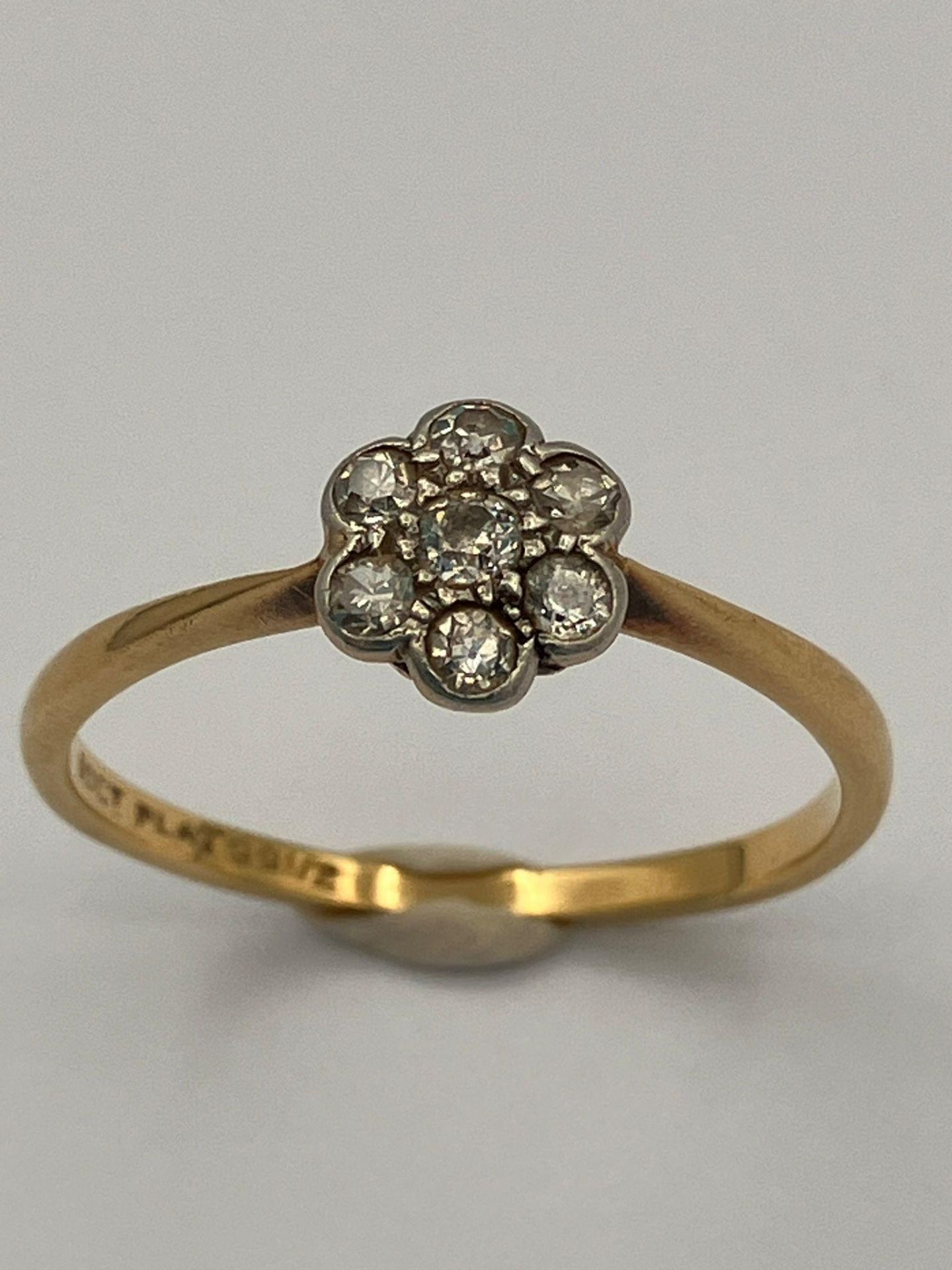 Vintage 18 carat GOLD RING with PLATINUM set DIAMONDS mounted in floral formation. 1.9 grams. Size P