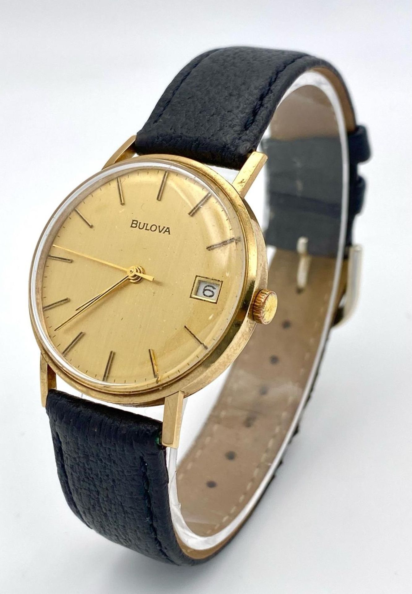 A Vintage Bulova 9K Gold Cased Mechanical Gents Watch. Black leather strap. 9K gold inscribed case -
