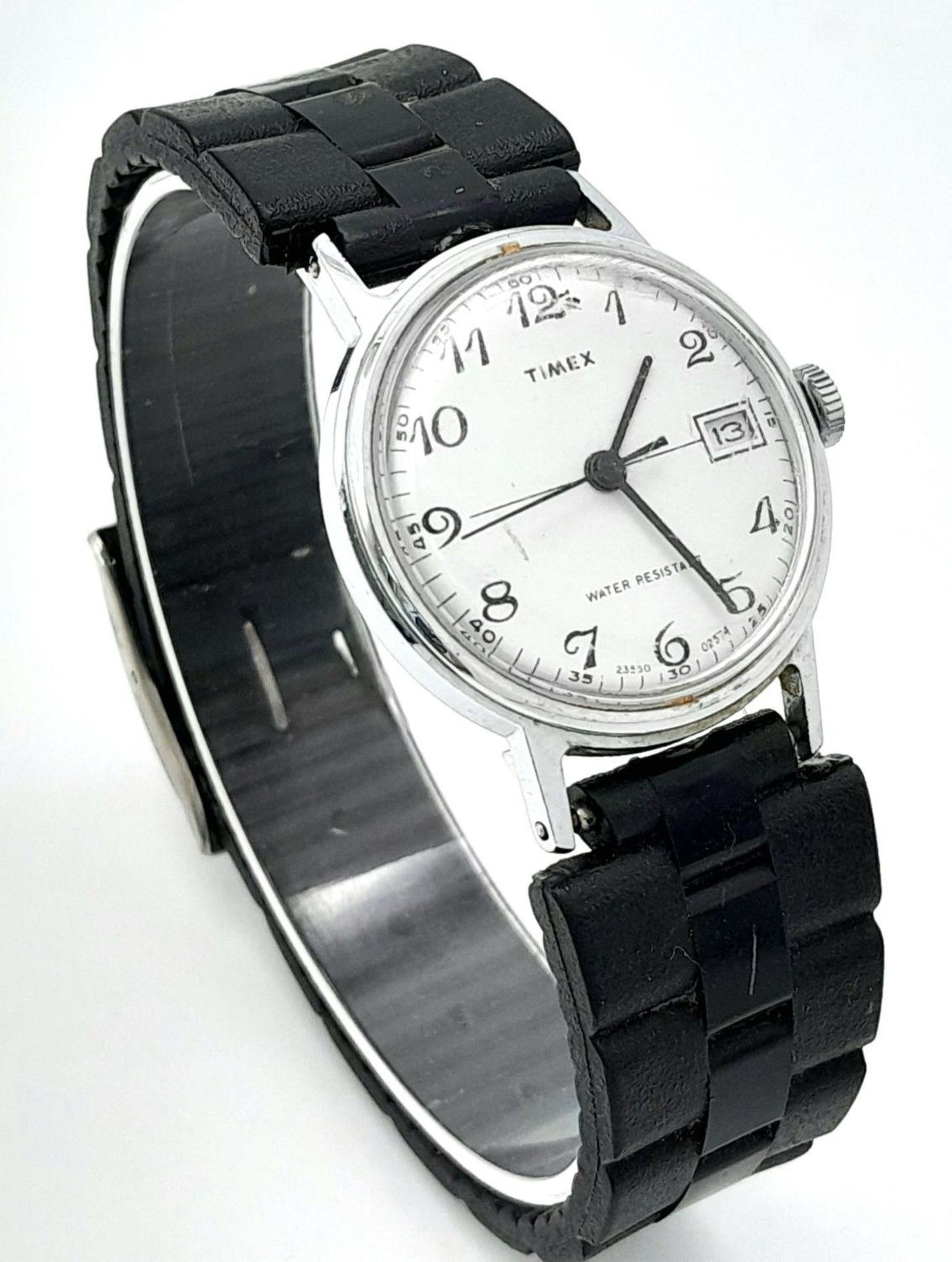 A Vintage Timex Mechanical Watch. Black rubber strap. Stainless steel case - 30mm. White dial with