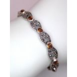 A Marcasite and Citrine Bracelet. White metal, boxed. 18cm