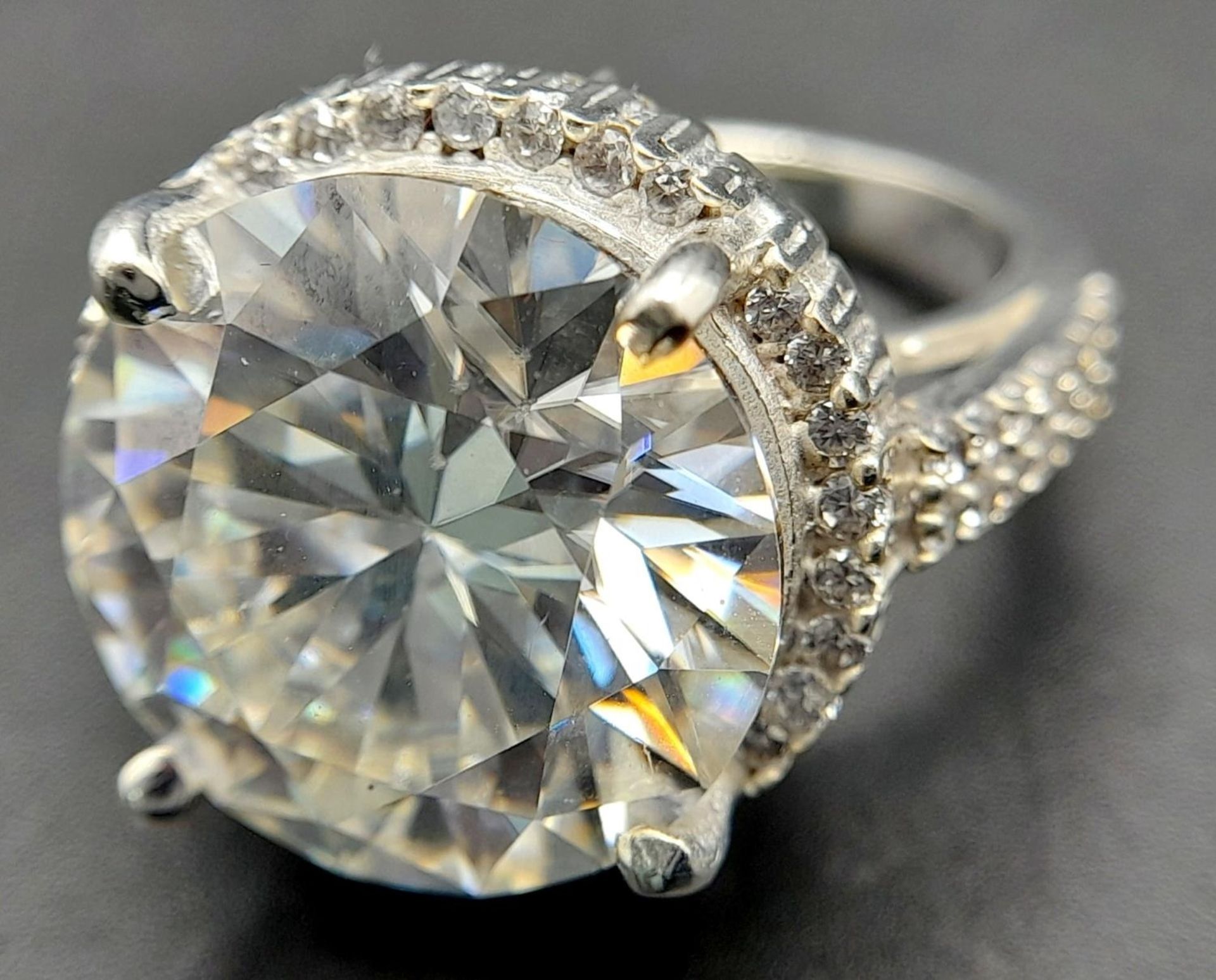An 11.40ct White Moissanite Statement Dress Ring. Set in 925 Silver. Size O. 8g total weight.