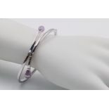 A 9K WHITE GOLD AMETHYST SET BANGLE. 8.1G.