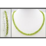 A Peridot Gemstone Tennis Bracelet with a Peridot Rondelle Necklace. Both with silver clasps.