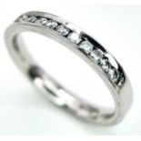 A PLATINUM DIAMOND HALF ETERNITY RING. 0.25ctw, size J, 4.1g total weight. Ref: SC 9078