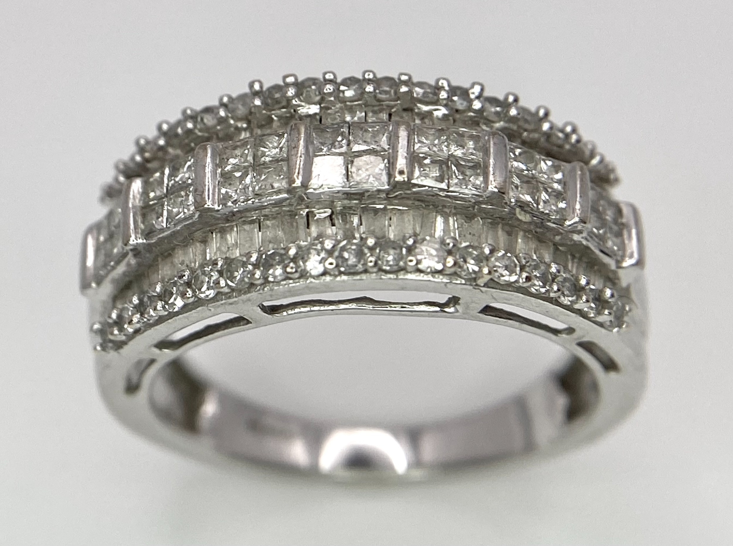 A 9K White Gold Mixed Cut Diamond Ring. Five rows of, square, round and baguette cut diamonds. - Image 3 of 7