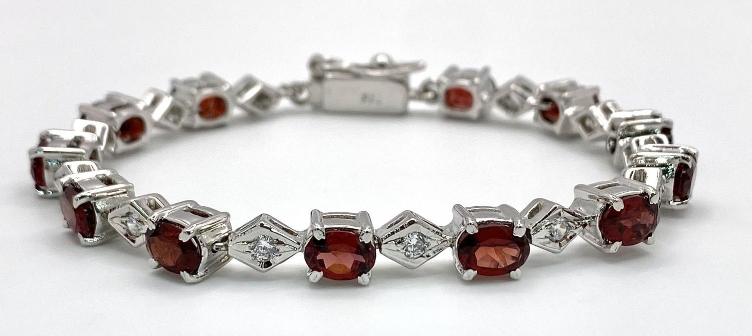 A Garnet and White Zircon Tennis Bracelet set in 925 Sterling silver. 32ctw. W-23.80g. Ref: HV2159