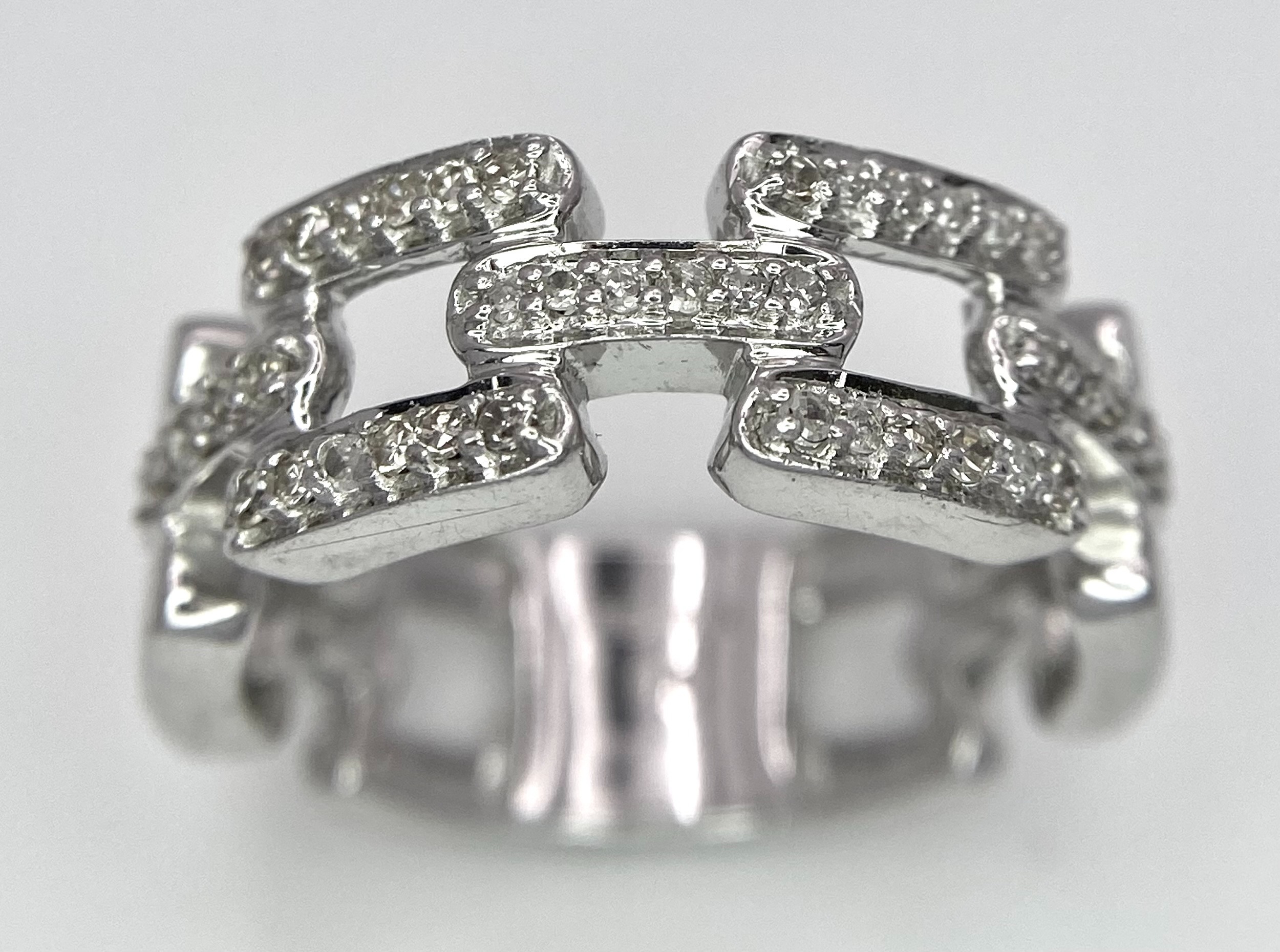 A 9K WHITE GOLD DIAMOND SET LINK RING. 0.25ctw, Size N, 4.7g total weight. Ref: SC 8003