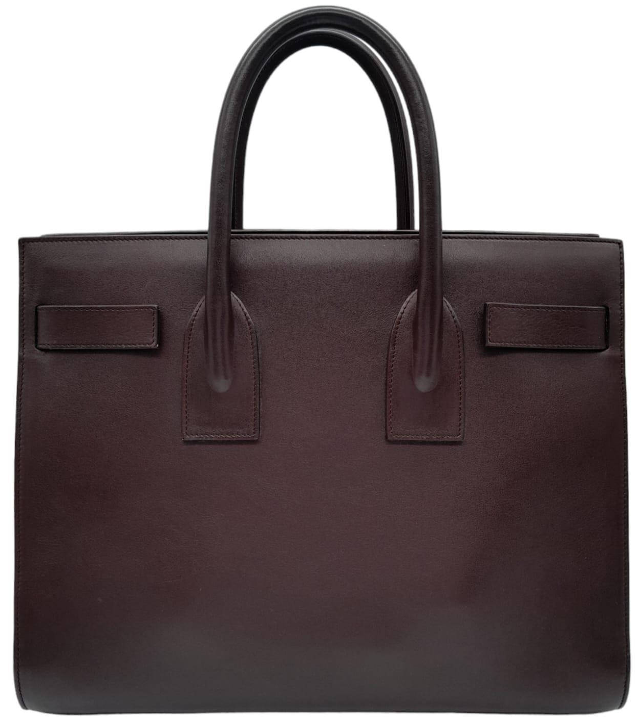 A Saint Laurent Sac De Jour Burgundy Handbag. Leather Exterior, Gold Tone Hardware, Double Handle in - Image 2 of 9