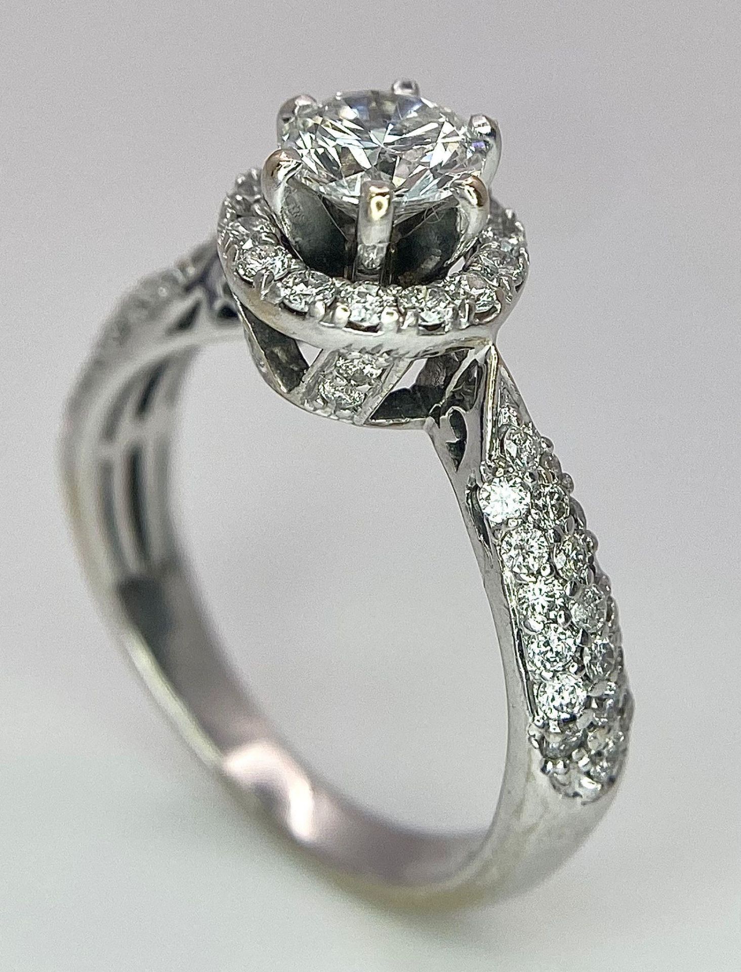 An 18K White Gold Diamond Ring. Central 0.75ct brilliant round cut diamond with a diamond halo and - Image 4 of 10