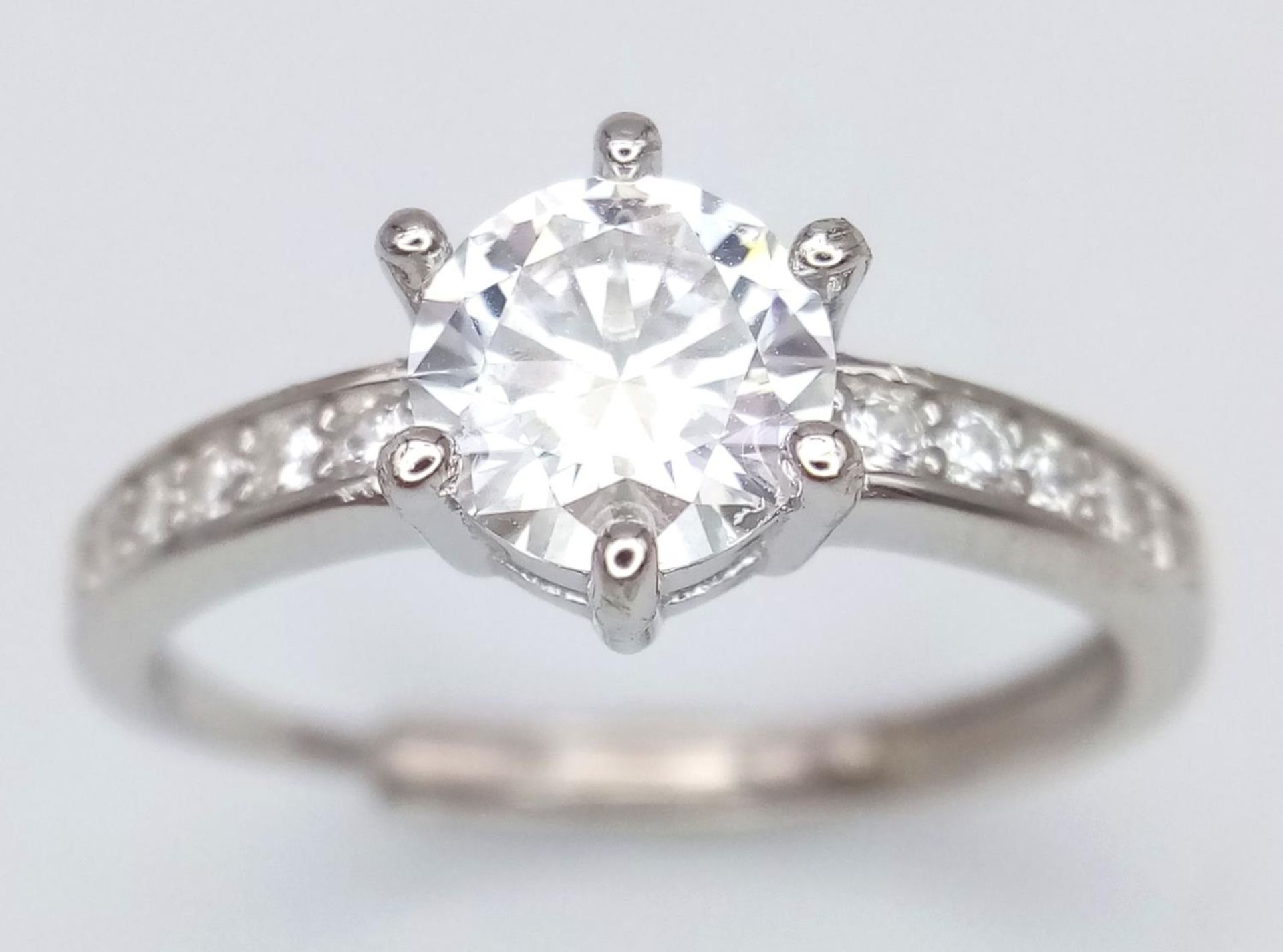 A 1ct Moissanite Ring set in 925 Silver. Size O. Comes with a GRA certificate.