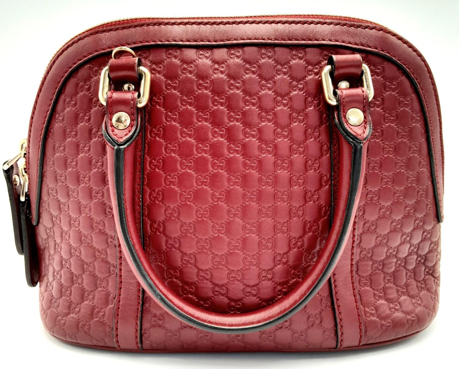 A Gucci Red Guccissima Dome Bag. Monogramed leather exterior with gold-toned hardware, two rolled - Image 2 of 10