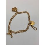 9 carat GOLD DOUBLE LINK BRACELET. Complete with safety chain and having Heart Padlock fastening