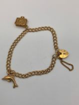 9 carat GOLD DOUBLE LINK BRACELET. Complete with safety chain and having Heart Padlock fastening
