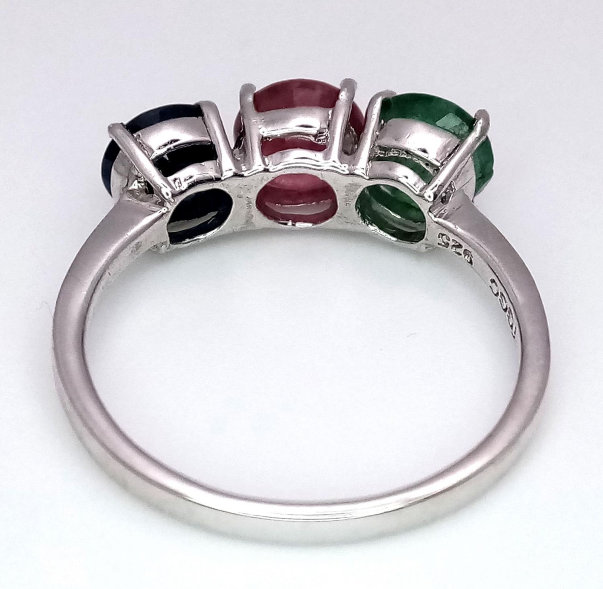 An Emerald, Sapphire and Ruby Three Stone Ring on 925 Silver. Size N1/2, 2.4g total weight. - Image 4 of 5